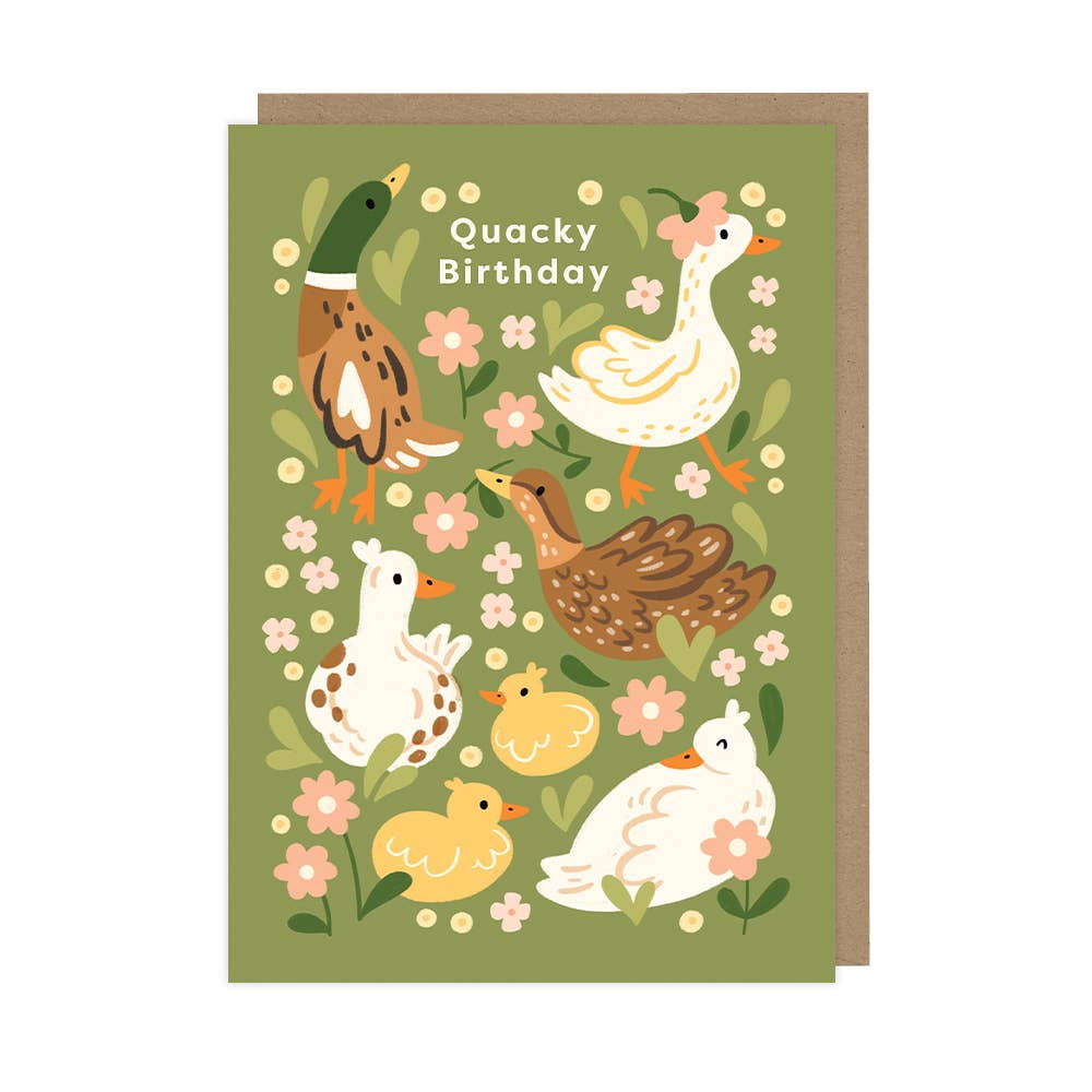 A greeting card with an illustration of ducks and flowers, with the text 'Quacky Birthday' on the front. The card is green with a kraft envelope.