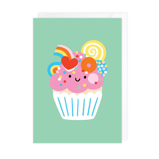 Colorful cartoon cupcake with rainbow and flowers on a green background