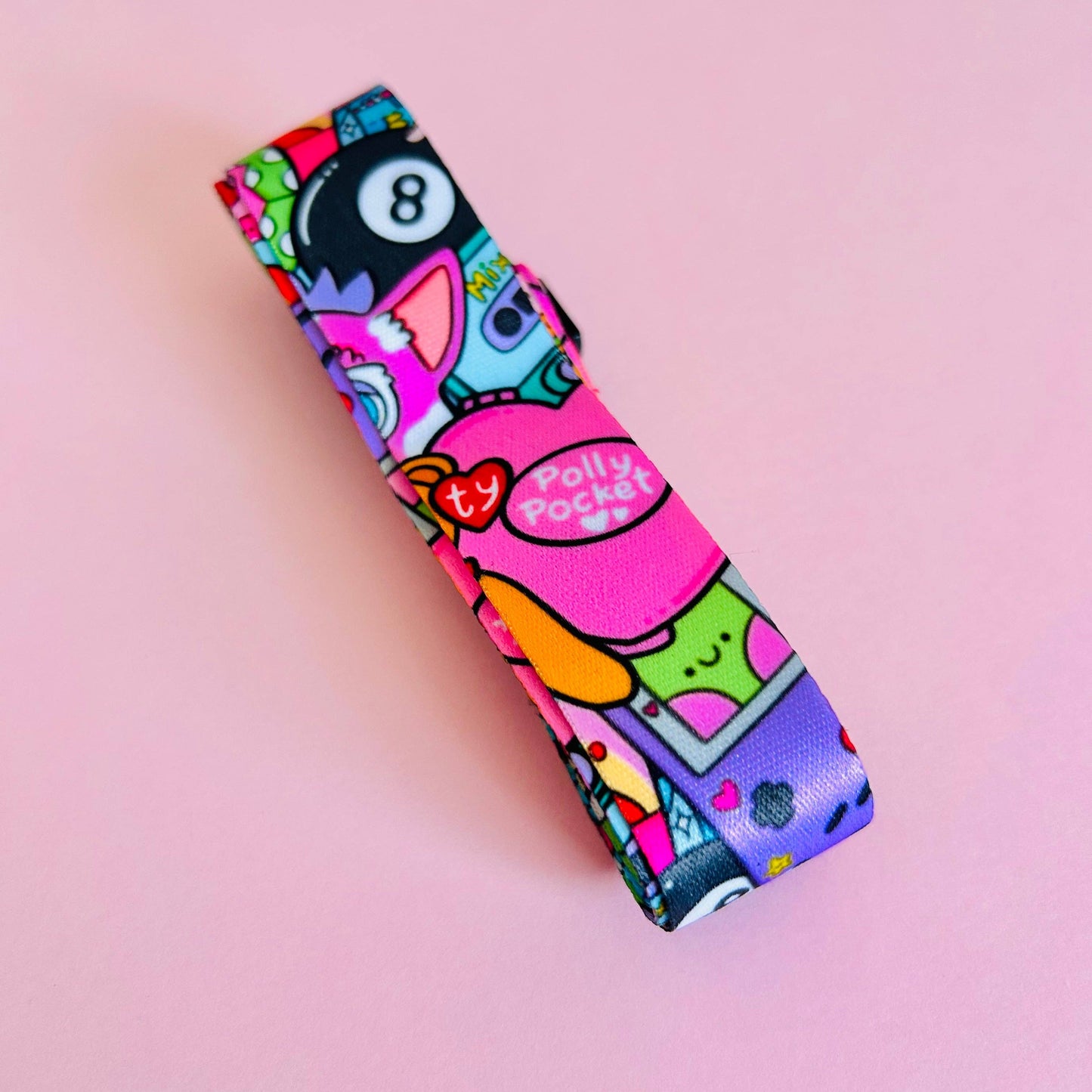 Colorful lip balm case with cartoon characters on a pink background
