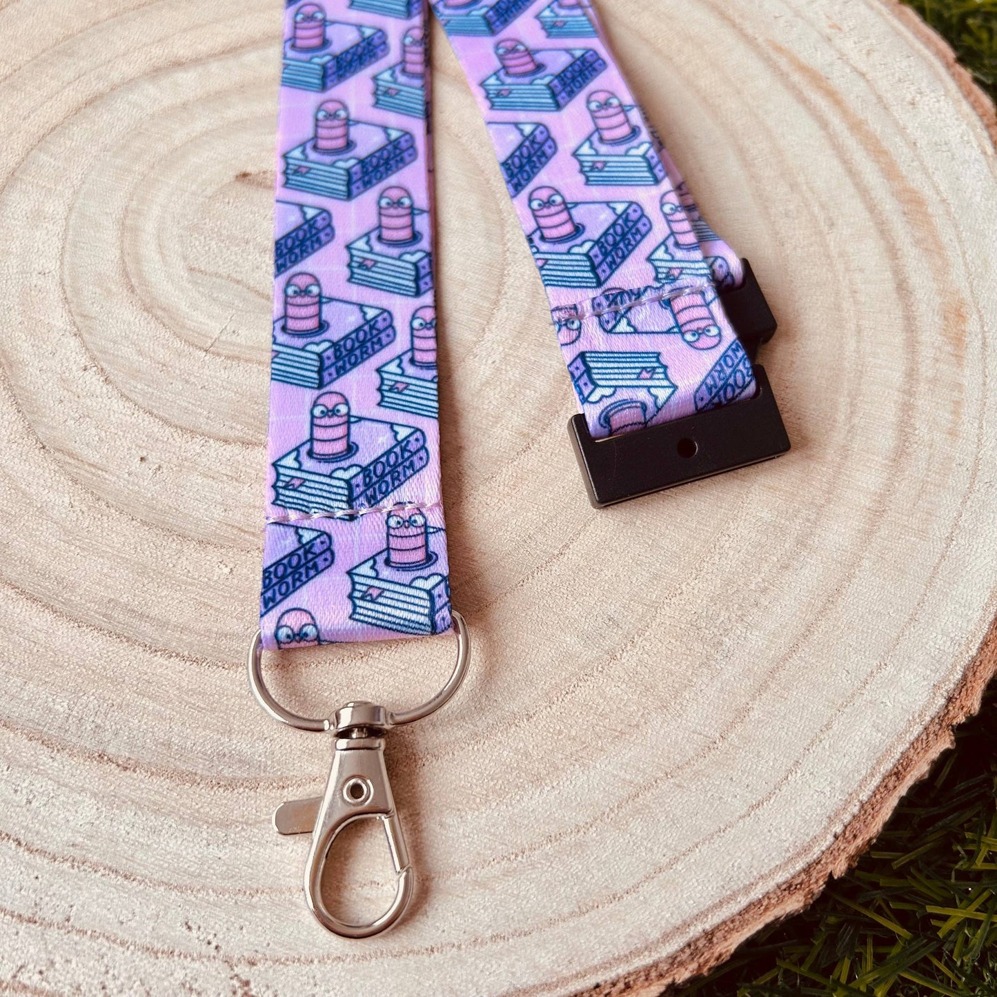 Lanyard with a pink and blue pattern on a wooden surface