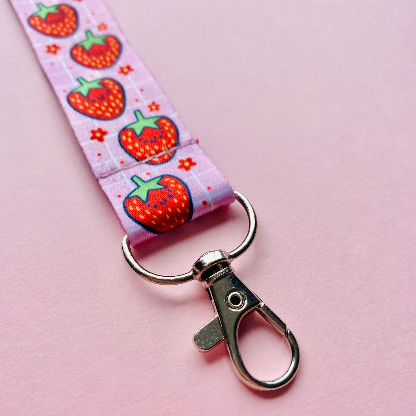 Keychain with strawberry pattern on a pink background