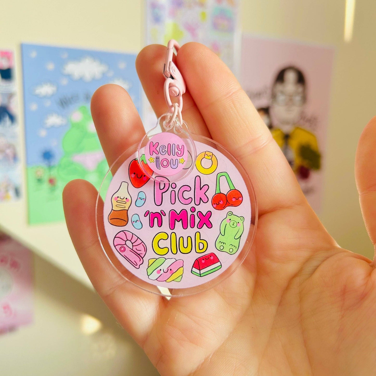 Hand holding a colorful keychain with 'Pick 'n' Mix Club' text and graphics.