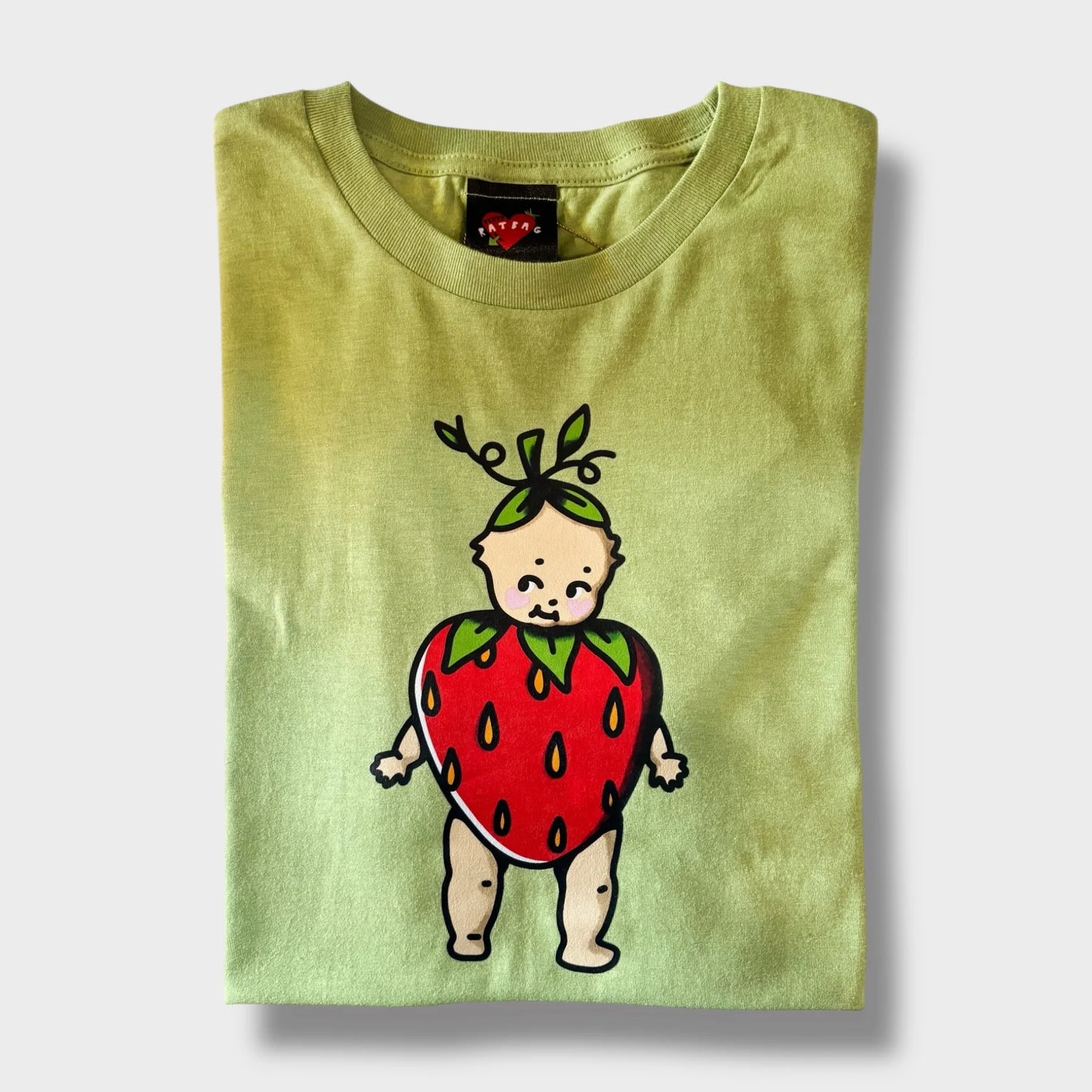 Green t-shirt with a cartoon baby in a strawberry costume on a white background