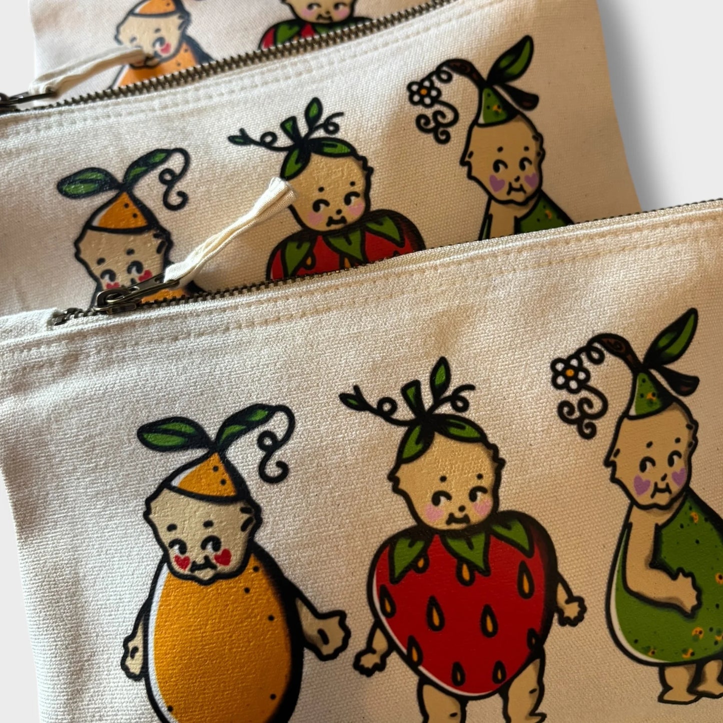 Two pouches with cartoon characters on a beige background