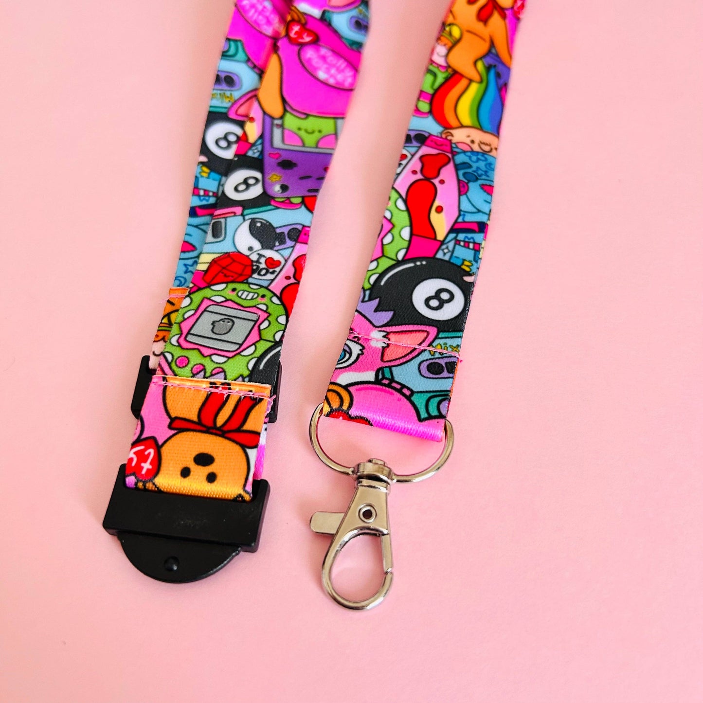 Colorful lanyard with cartoon designs on a pink background