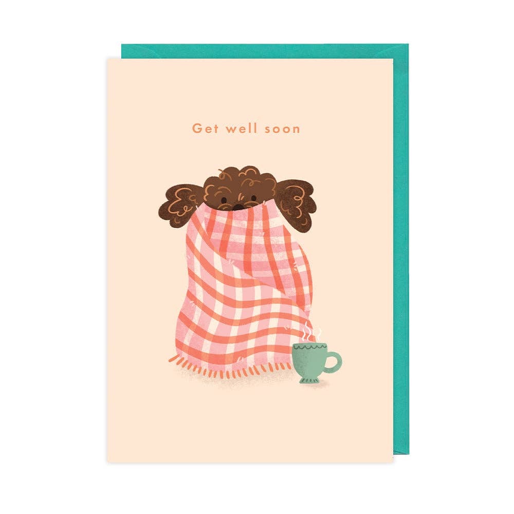 Greeting card with illustration of a person wrapped in a pink checkered towel, holding a green mug, on a beige background.