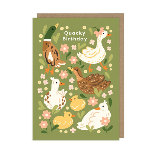 A greeting card with an illustration of ducks and flowers, with the text 'Quacky Birthday' on the front. The card is green with a kraft envelope.