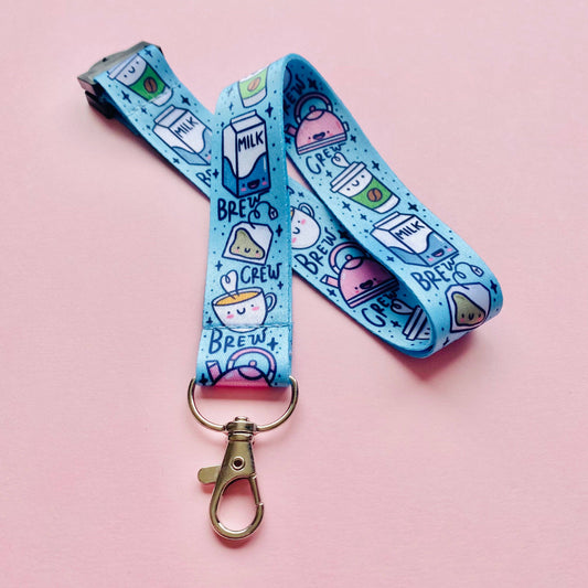 Blue lanyard with cartoon designs on a pink background