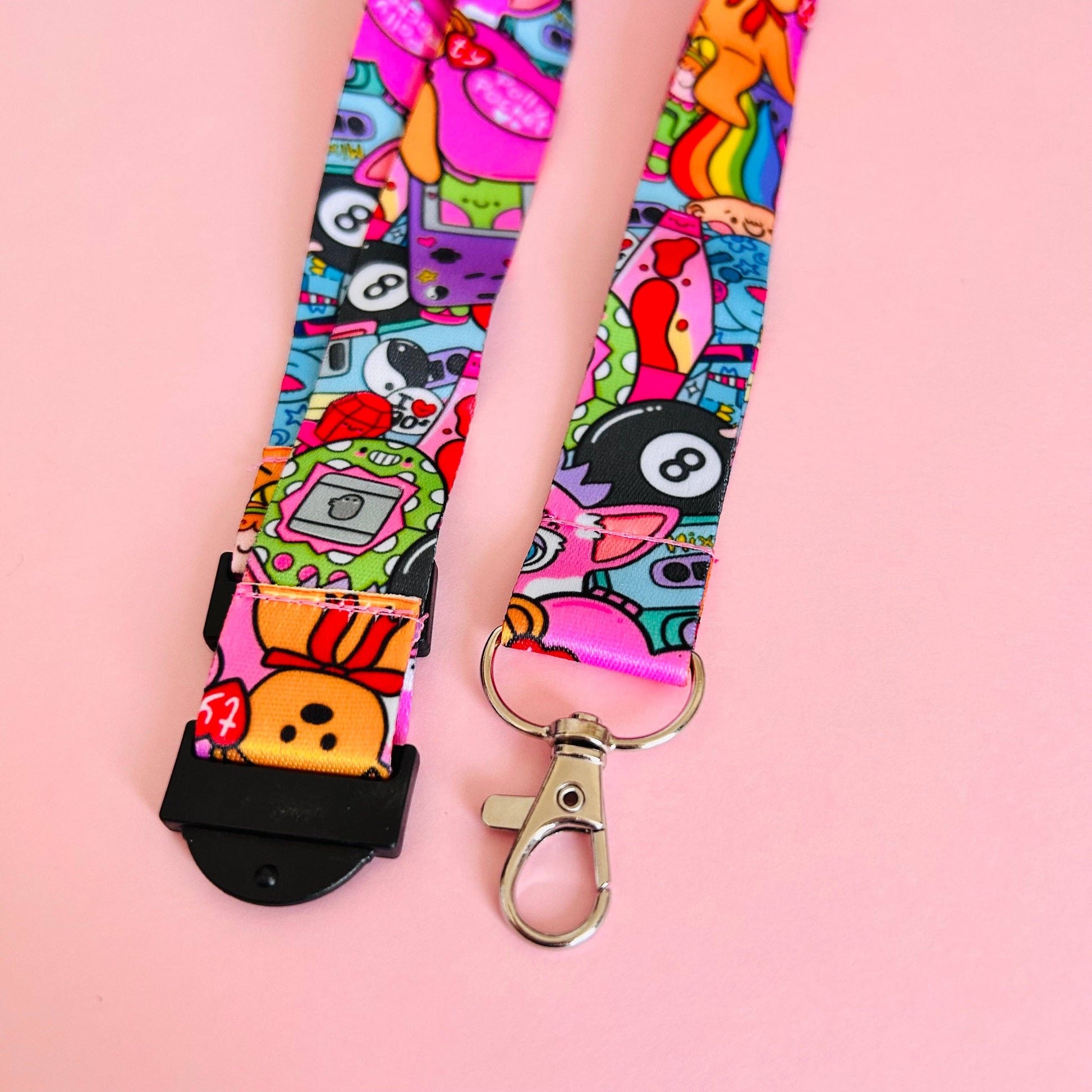 Colorful lanyard with cartoon designs on a pink background